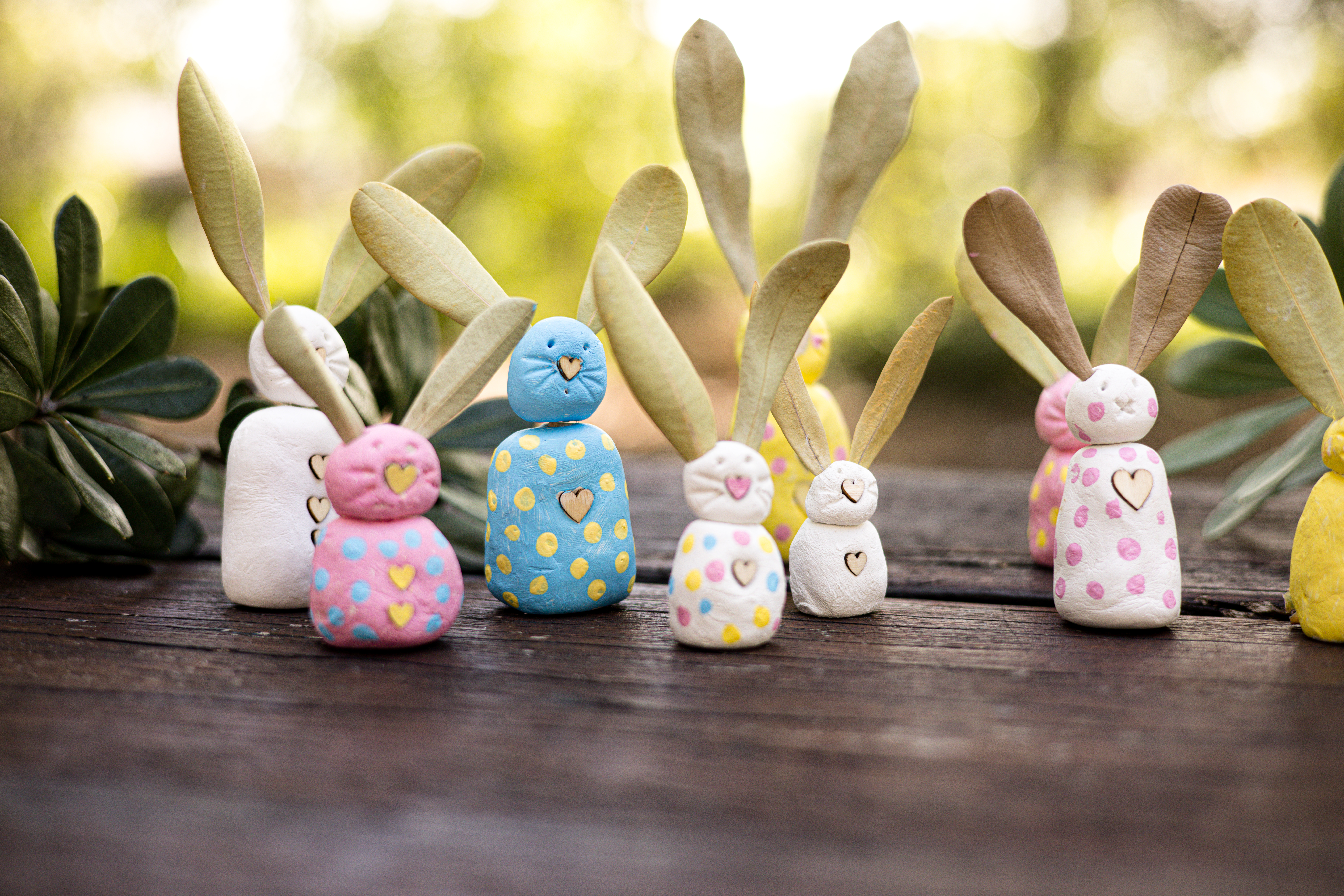 diy clay bunnies lined in the forest
